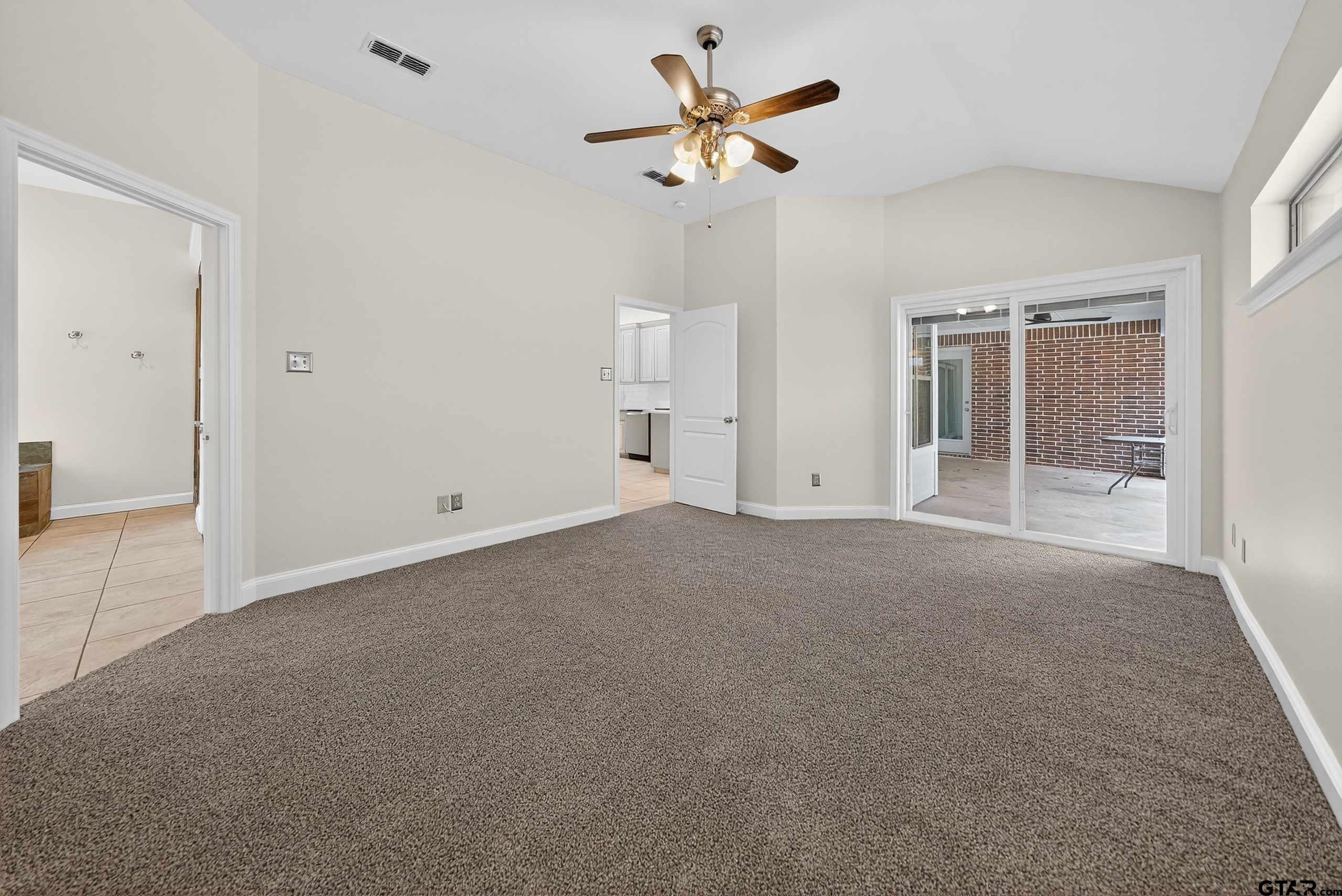 21112 Altuda Lane Flint, TX 75762 - Photo 23 of 48 an empty room with chandelier fan and windows