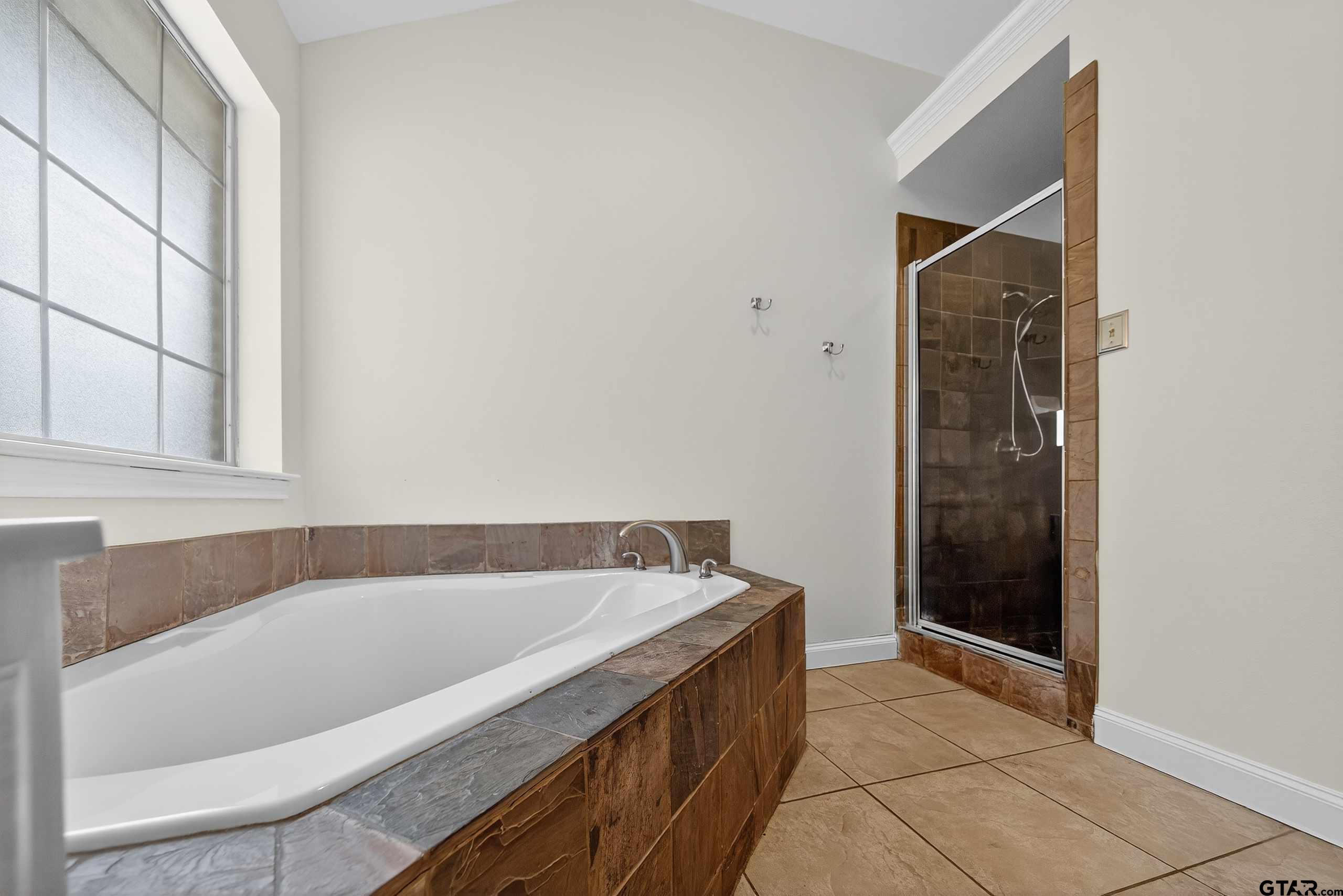 21112 Altuda Lane Flint, TX 75762 - Photo 25 of 48 a bathroom with a bathtub and a shower