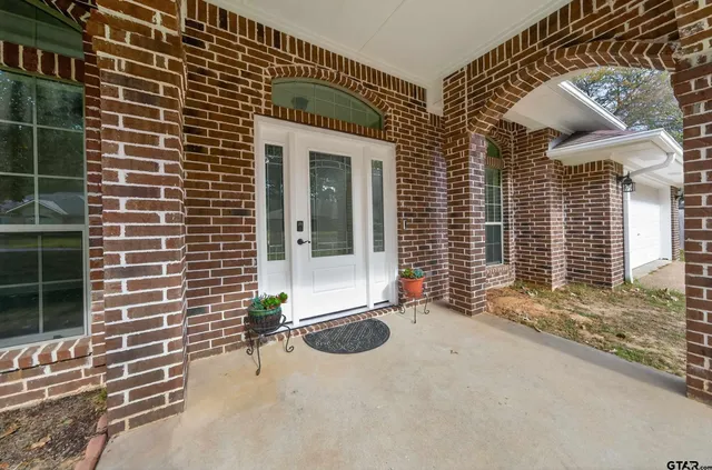 a view of a brick house with a large windows