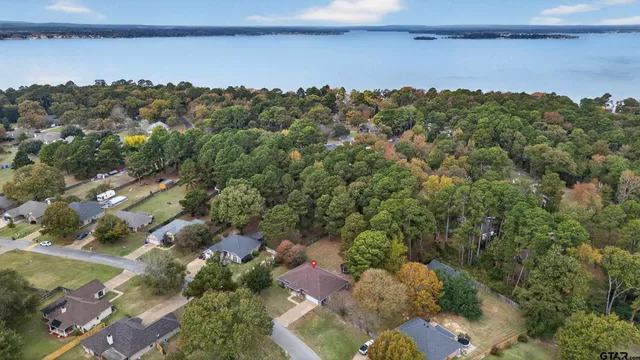 an aerial view of a house with a yard