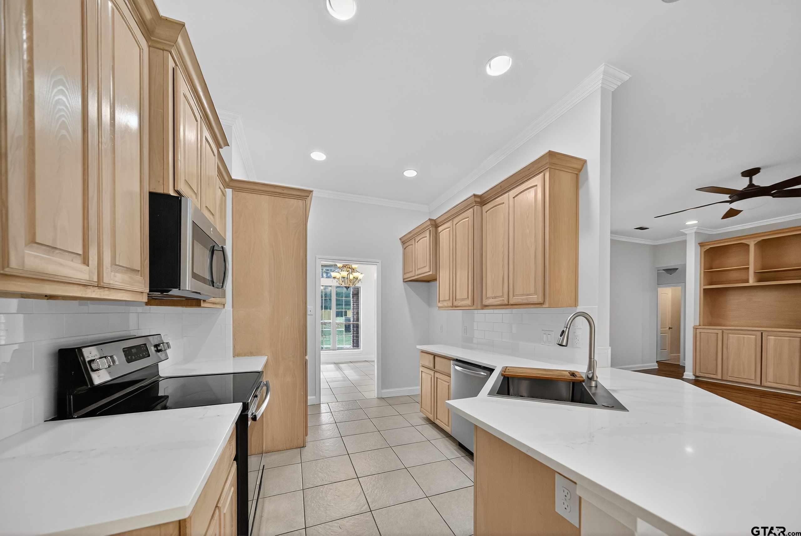 21112 Altuda Lane Flint, TX 75762 - Photo 9 of 48 a kitchen that has a sink and a stove top oven