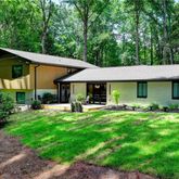 a front view of a house with swimming pool having outdoor seating