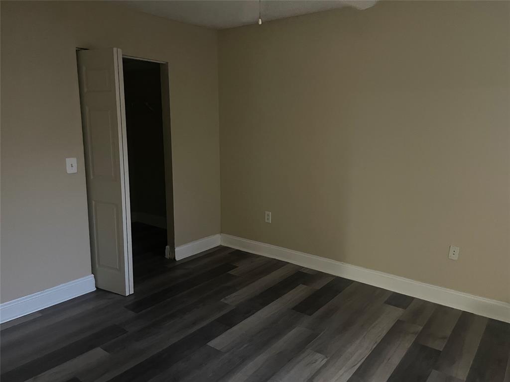 4179 Haverhill Road, Unit 602 West Palm Beach, FL 33417 - Photo 13 of 15 an empty room with wooden floor