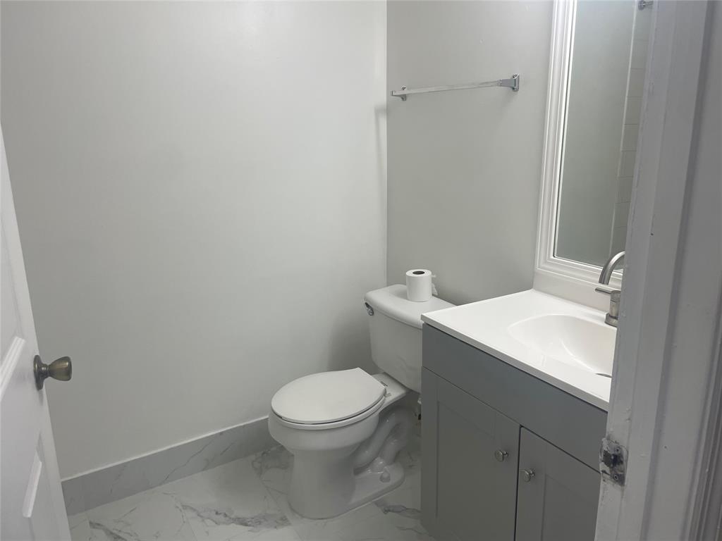 4179 Haverhill Road, Unit 602 West Palm Beach, FL 33417 - Photo 14 of 15 a white toilet sitting next to a bathroom sink