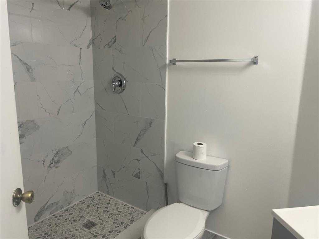 4179 Haverhill Road, Unit 602 West Palm Beach, FL 33417 - Photo 15 of 15 a white toilet sitting next to a shower