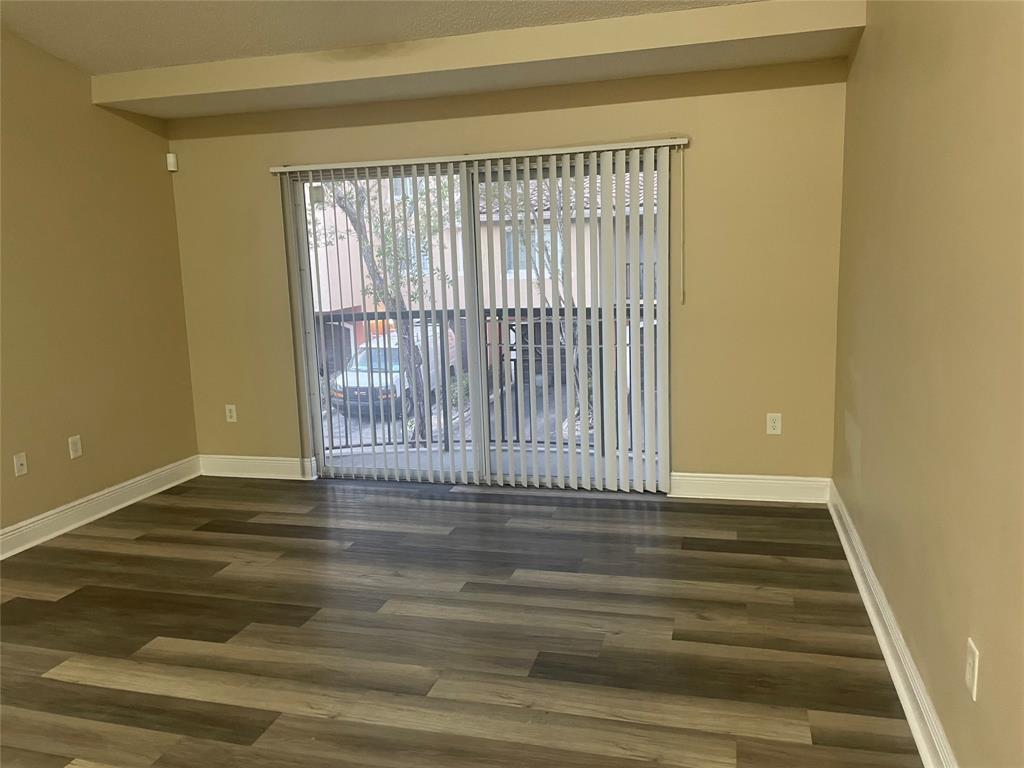 4179 Haverhill Road, Unit 602 West Palm Beach, FL 33417 - Photo 6 of 15 a view of a room with wooden floor and a window