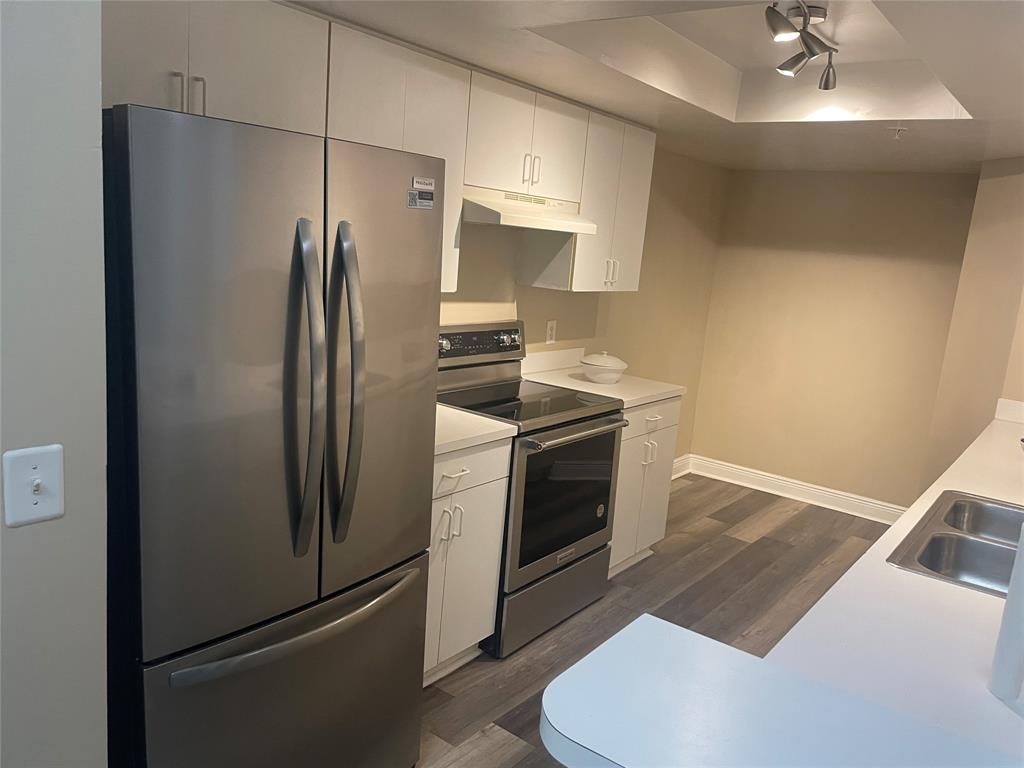 4179 Haverhill Road, Unit 602 West Palm Beach, FL 33417 - Photo 8 of 15 a kitchen with stainless steel appliances a refrigerator sink and stove