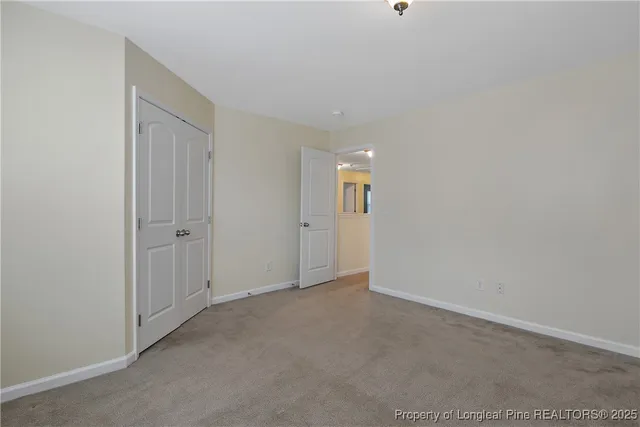 a view of an empty room and closet area