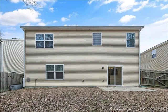 a view of a hallway with wooden floor and entryway