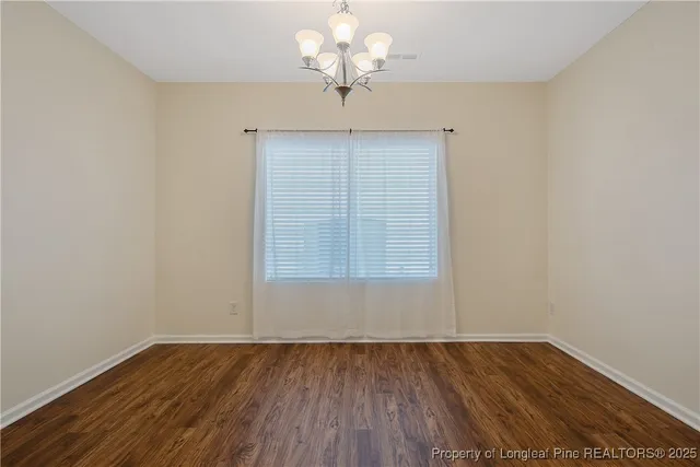 a view of a livingroom with a ceiling fan and window