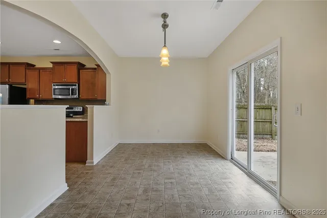 a kitchen with stainless steel appliances granite countertop a stove a sink dishwasher and a refrigerator