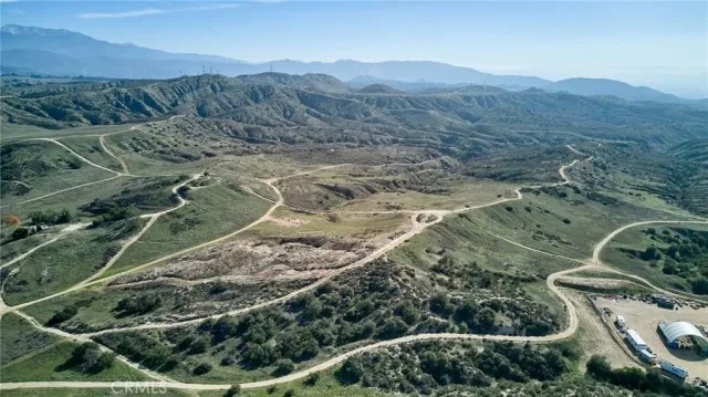 a view of a lush green hillside and a mountain