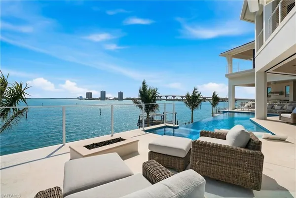 a view of a patio with couches and a table and chairs with garden view