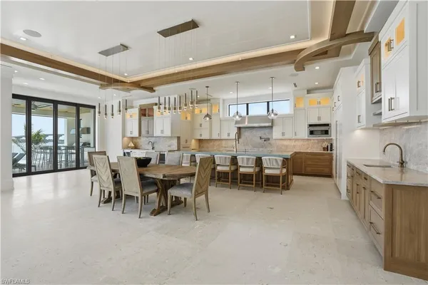 a large kitchen with a table and chairs