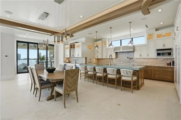 a large kitchen with a table and chairs