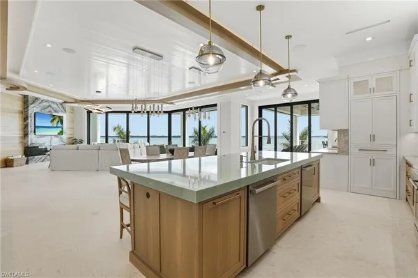 a large white kitchen with a large window