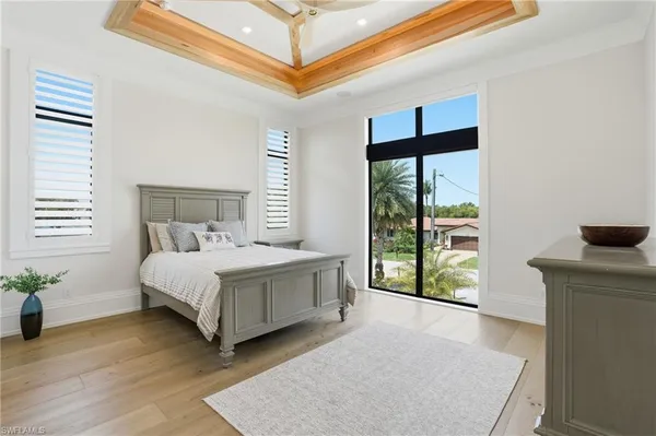 a bedroom with a bed and a large window