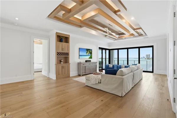 a living room with furniture and large windows