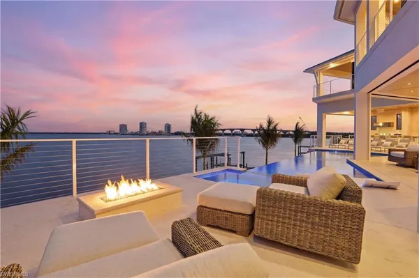 a view of a roof deck with couches and potted plants