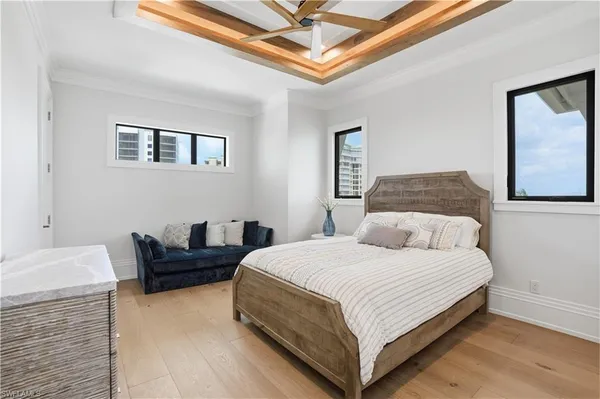 a bedroom with a bed couch and window