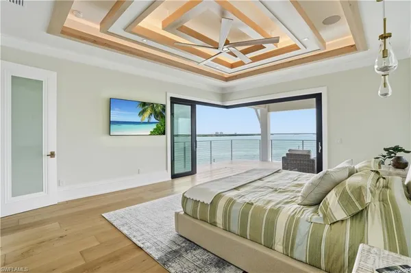 a bedroom with a bed and a large window