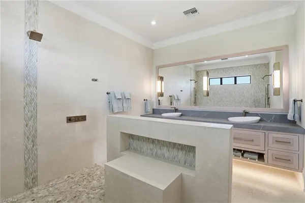 a spacious bathroom with a sink a mirror and a shower