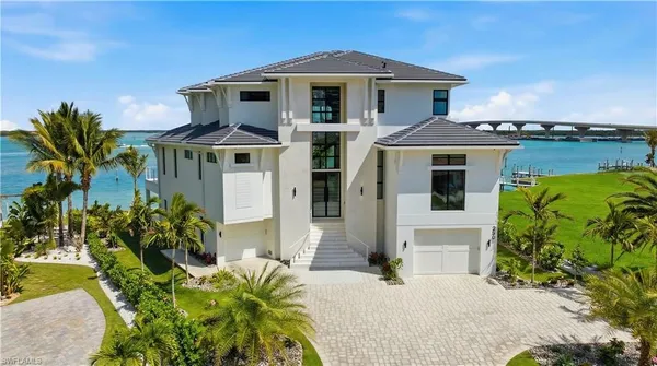 a front view of a residential apartment building with a yard