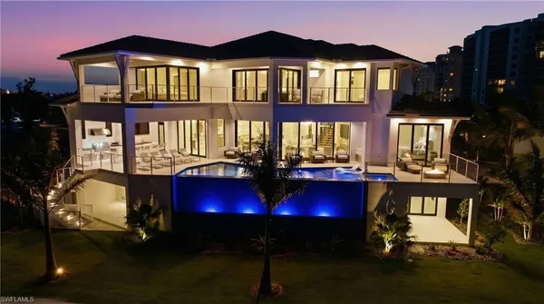 a view of swimming pool with a table and chairs
