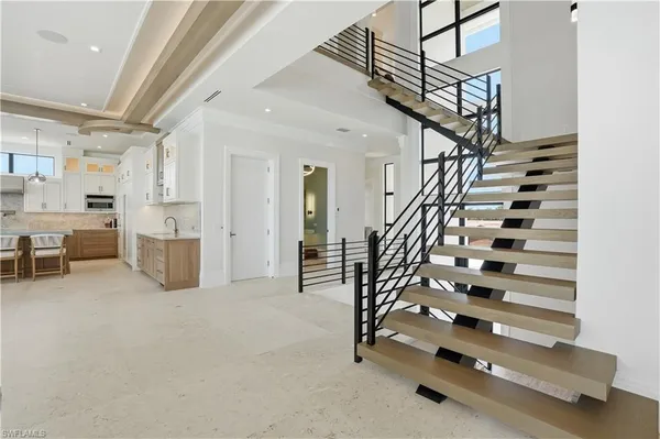 a view of hall way with furniture and staircase
