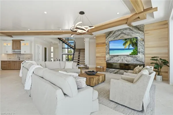 a living room with fireplace furniture and a chandelier