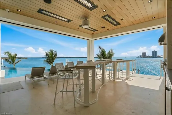 a view of a patio with dining table and chairs with potted plants