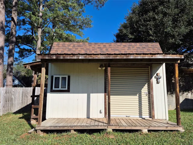 a view of a house with a wooden fence