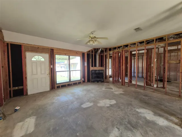 an empty room with furniture and a window