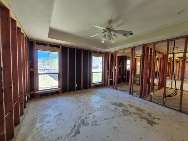 a view of an empty room with closet and a window