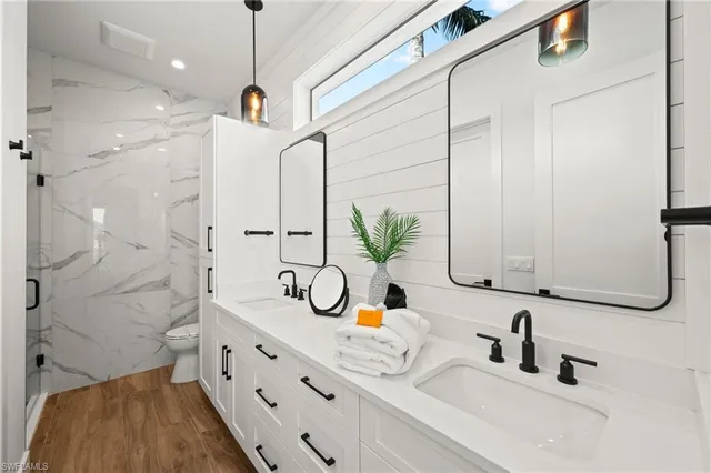 a bathroom with double vanity sink and a mirror