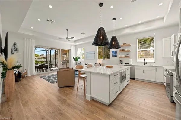 a kitchen with a sink stove and wooden floor
