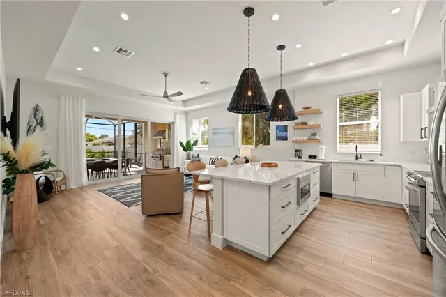 a kitchen with a sink stove and wooden floor