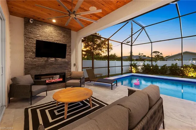 a outdoor living space with furniture and a flat screen tv
