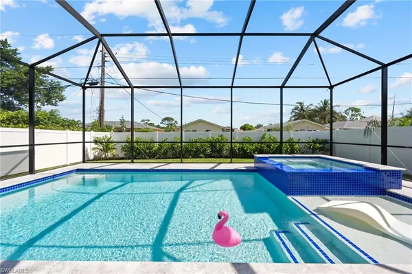a view of swimming pool with seating area and roof