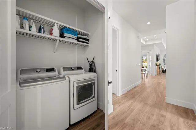 a view of washer and dryer with wooden floor