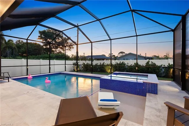 a view of a patio with a table and chairs under an umbrella