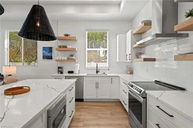 a kitchen with a sink a stove and a window