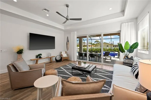 a living room with furniture a large window and a flat screen tv