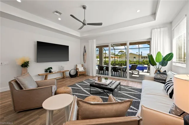 a living room with furniture a large window and a flat screen tv