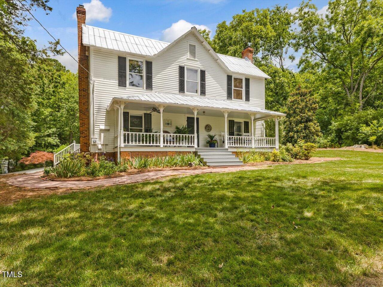967 Bynum Road Pittsboro, NC 27312 - Photo 2 of 100 a front view of a house with a yard