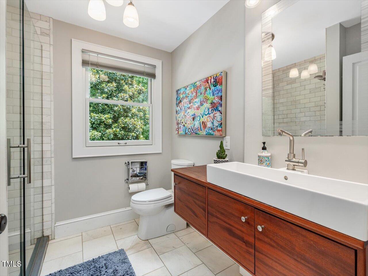 967 Bynum Road Pittsboro, NC 27312 - Photo 28 of 100 a spacious bathroom with a double vanity sink toilet and a mirror