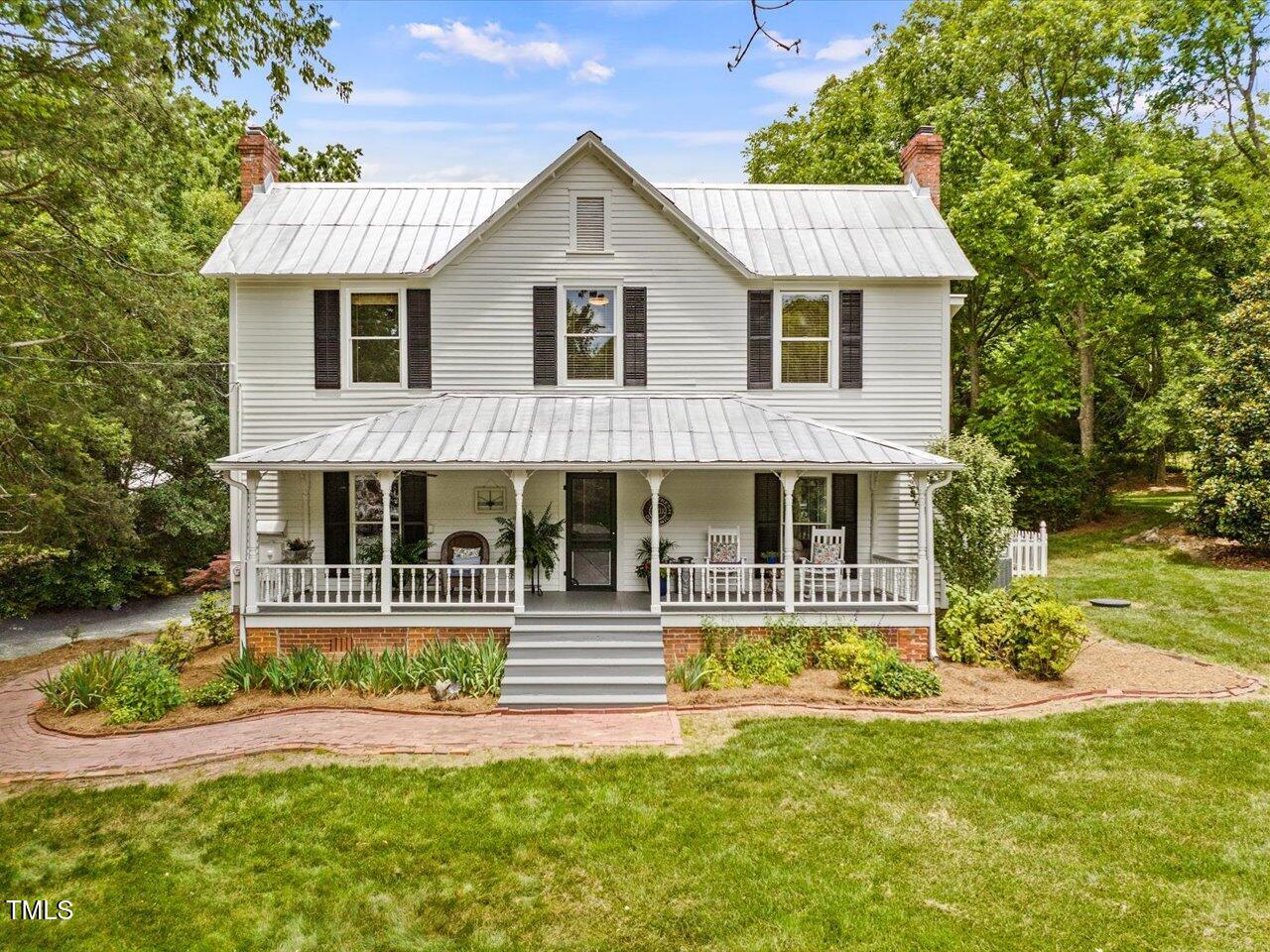 967 Bynum Road Pittsboro, NC 27312 - Photo 3 of 100 a front view of a house with a yard table and chairs