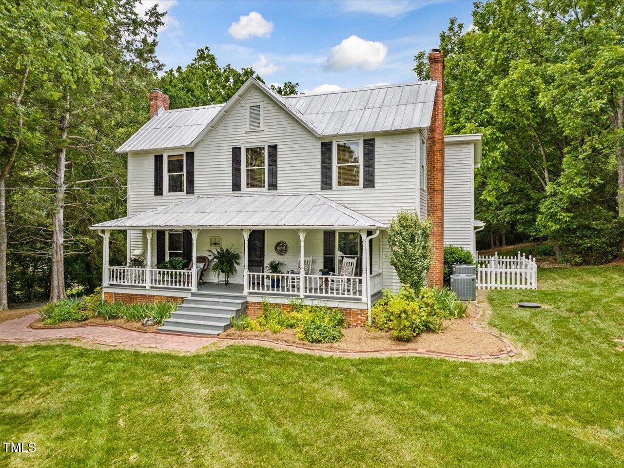 967 Bynum Road Pittsboro, NC 27312 - Photo 4 of 100 a front view of a house with a yard table and chairs