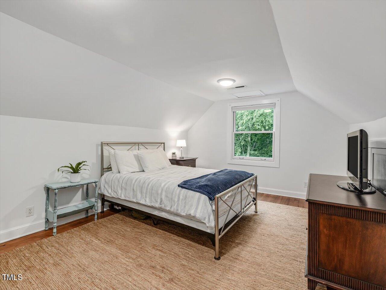 967 Bynum Road Pittsboro, NC 27312 - Photo 80 of 100 a bedroom with a bed and a flat screen tv