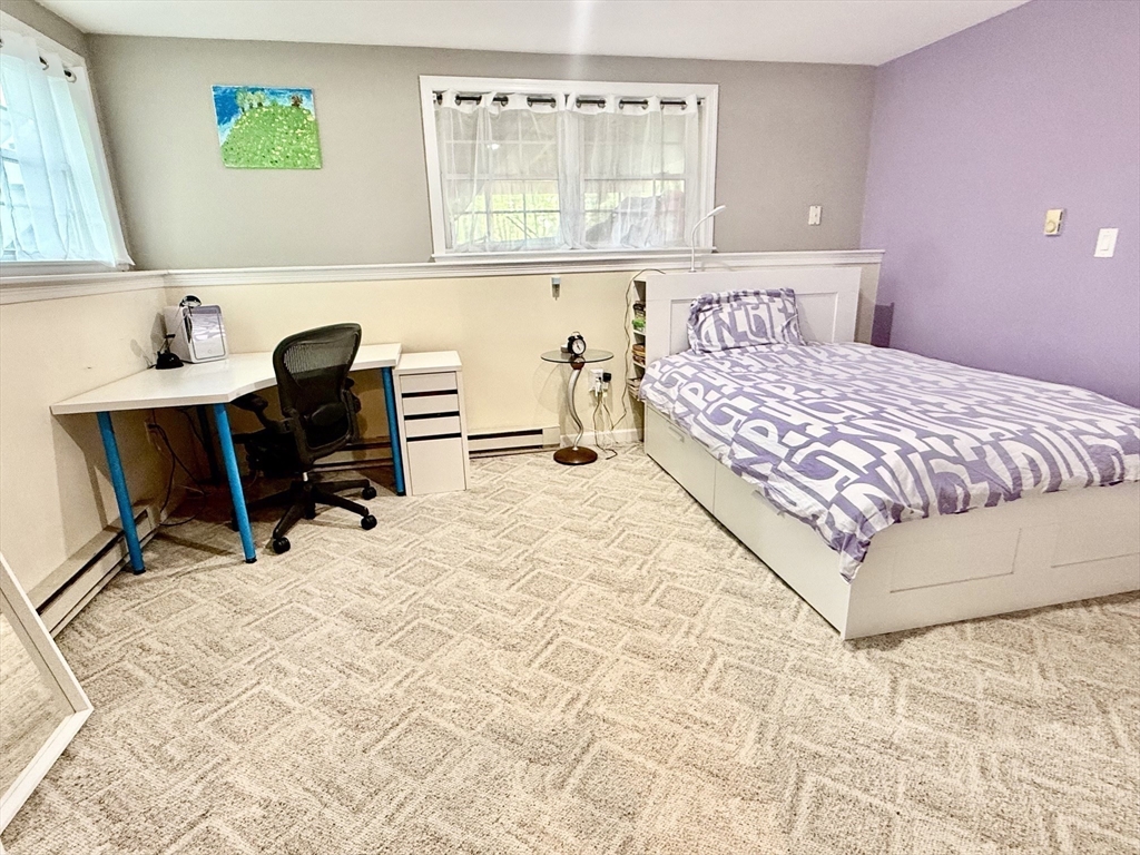 19 Fairview Road, Unit A Framingham, MA 01702 - Photo 9 of 28 a bedroom with a bed a desk and chair